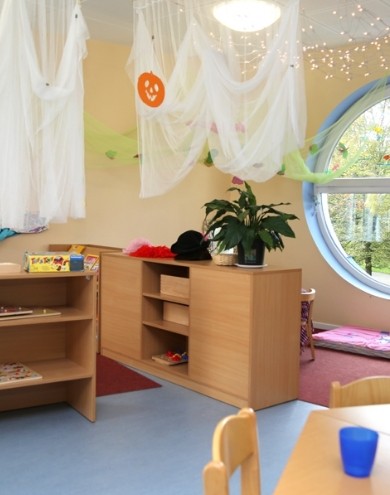 Bright room with a round window and Halloween decorations