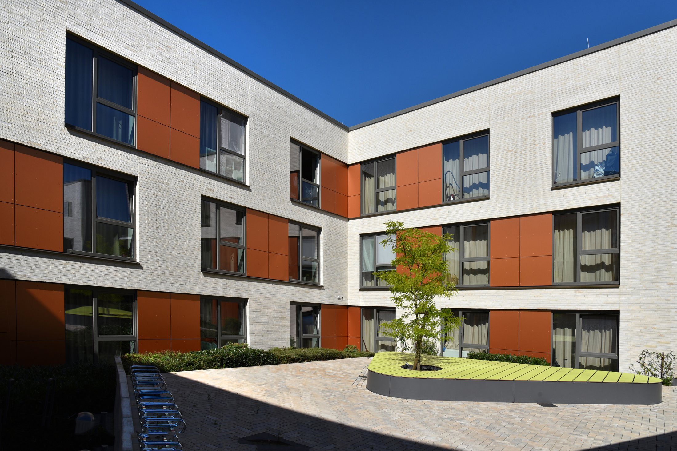Student residence in Paderborn - Alois Fuchs Weg, modern architecture with green inner courtyard and large windows.