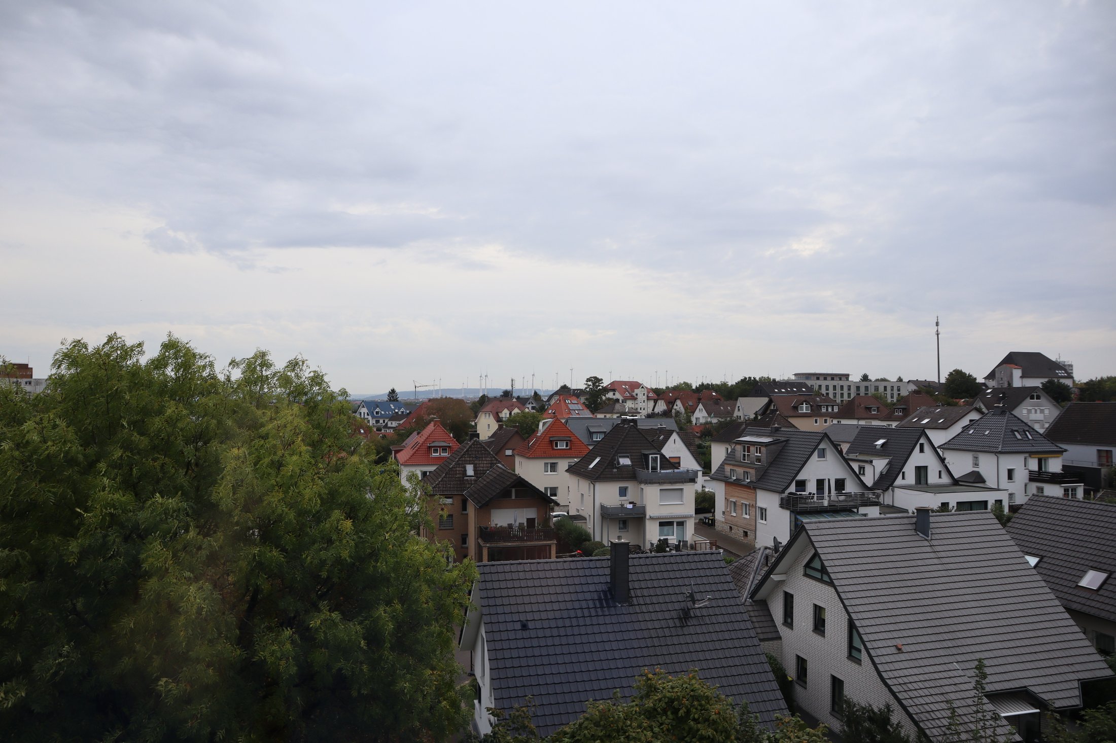 Panoramaaufnahme von Paderborn-Peter_Hille_Weg_13, mit einer Vielzahl von Wohnhäusern und bewaldeten Flächen.